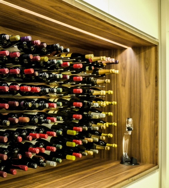 Mid-sized modern wine cellar in Sydney with storage racks.