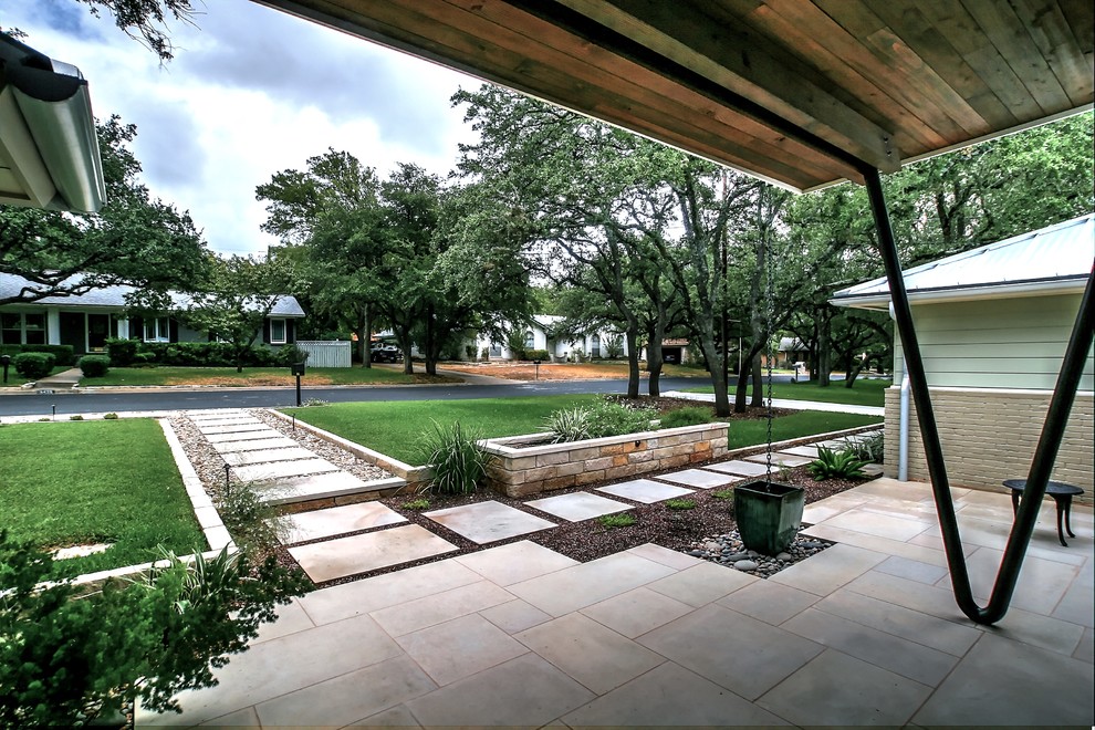 Design ideas for a large contemporary front yard full sun garden for spring in Austin with natural stone pavers and a garden path.