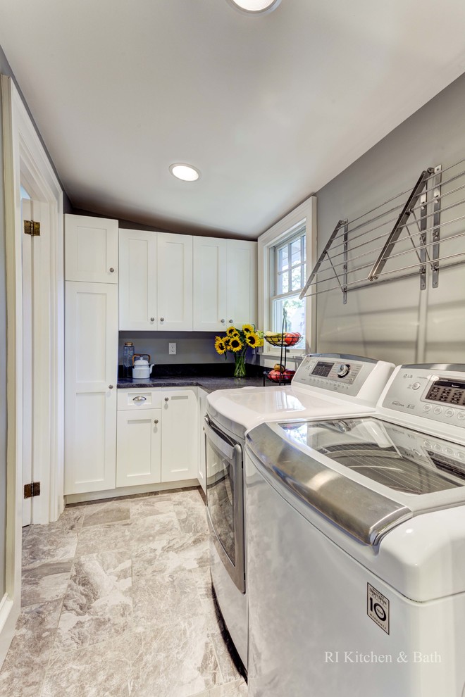 Mid-sized arts and crafts galley porcelain tile utility room photo in Providence with shaker cabinets, white cabinets, granite countertops, gray walls and a side-by-side washer/dryer