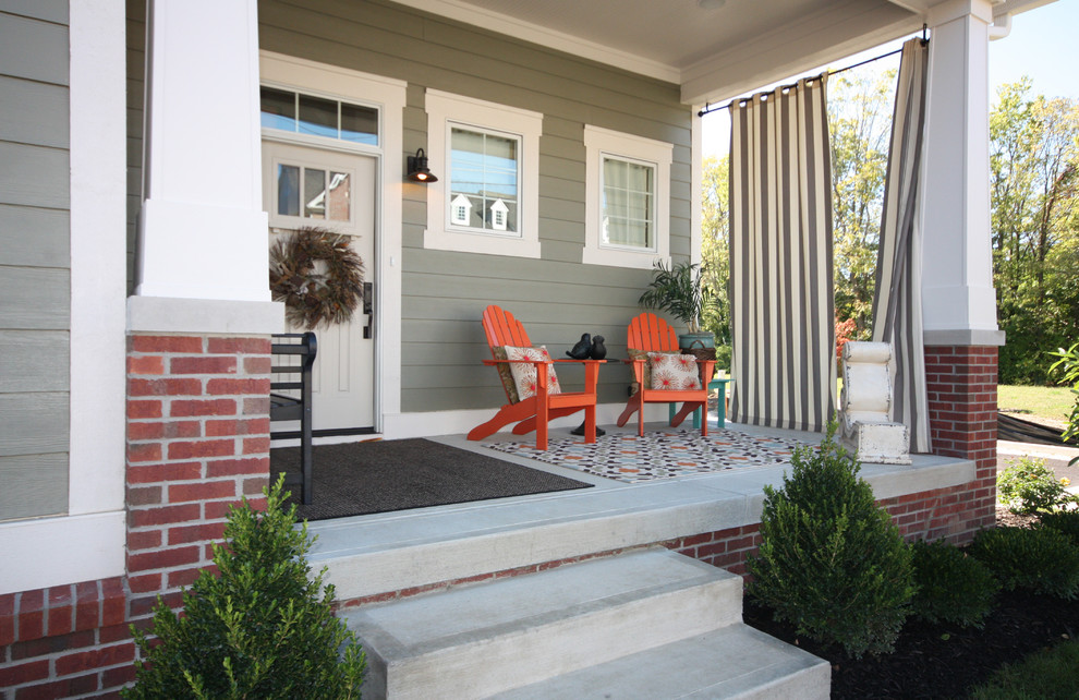 Design ideas for an arts and crafts front yard verandah in Indianapolis with concrete slab and a roof extension.