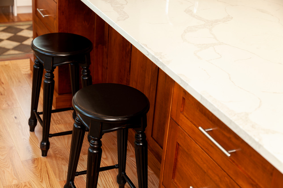 Inspiration for a mid-sized transitional l-shaped enclosed kitchen remodel with shaker cabinets, white cabinets, stainless steel appliances, an island and white countertops