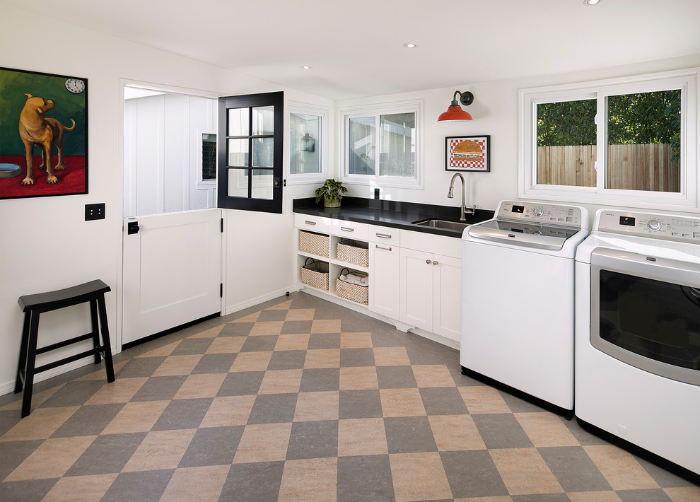 Design ideas for a mid-sized arts and crafts dedicated laundry room in Santa Barbara with an undermount sink, recessed-panel cabinets, white cabinets, soapstone benchtops and a side-by-side washer and dryer.