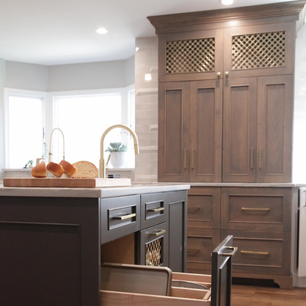 Large transitional l-shaped open concept kitchen photo with beaded inset cabinets, light wood cabinets, white backsplash, marble backsplash, stainless steel appliances and two islands