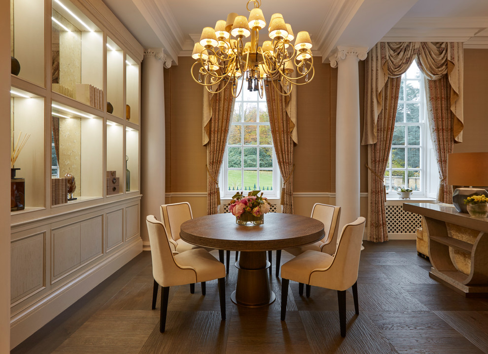 This is an example of a mid-sized traditional open plan dining in London with beige walls and dark hardwood floors.