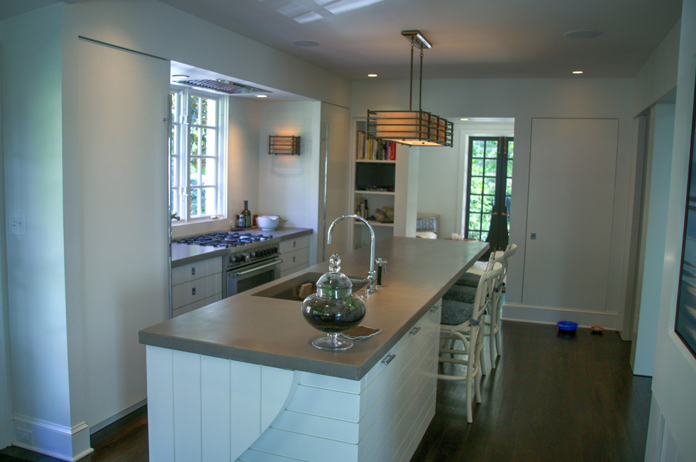 Photo of a mid-sized contemporary u-shaped eat-in kitchen in Charlotte with an undermount sink, flat-panel cabinets, white cabinets, white splashback, ceramic splashback, stainless steel appliances, dark hardwood floors and with island.
