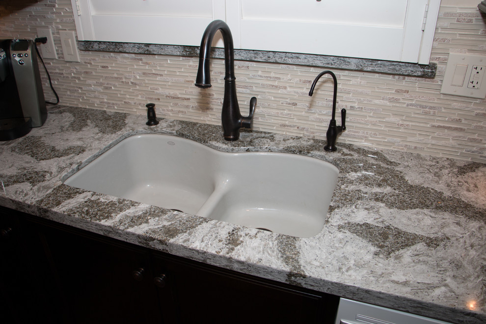 Inspiration for a mid-sized transitional l-shaped porcelain tile open concept kitchen remodel with an undermount sink, flat-panel cabinets, dark wood cabinets, quartz countertops, beige backsplash, glass sheet backsplash, white appliances and an island