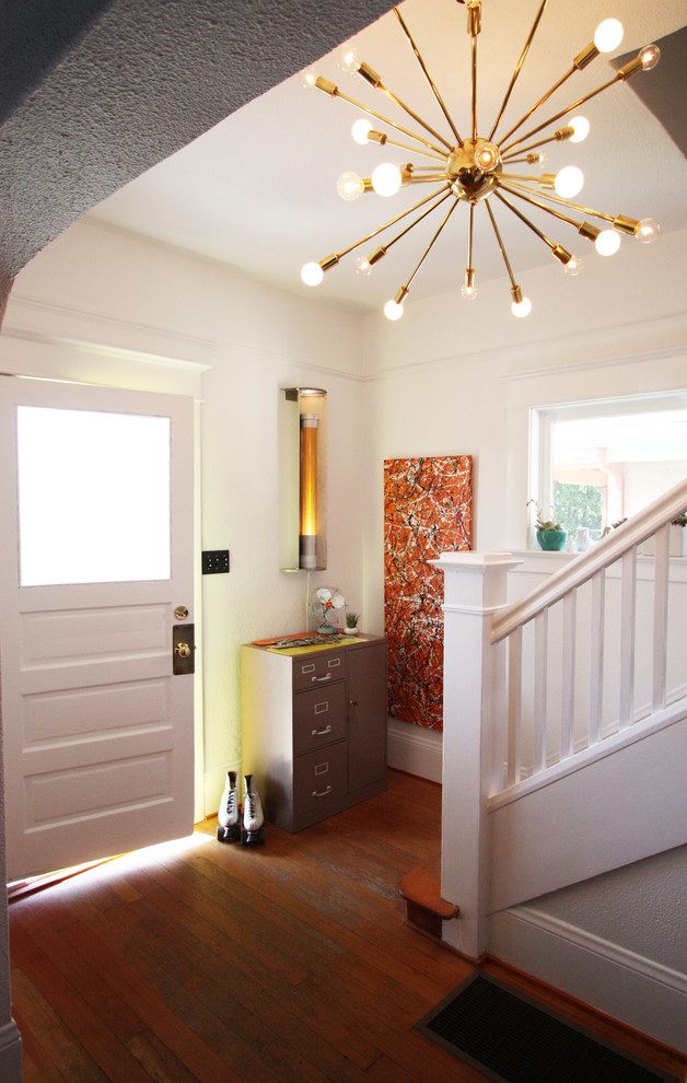 Design ideas for a small eclectic foyer in Portland with white walls, a single front door, medium hardwood floors and a white front door.