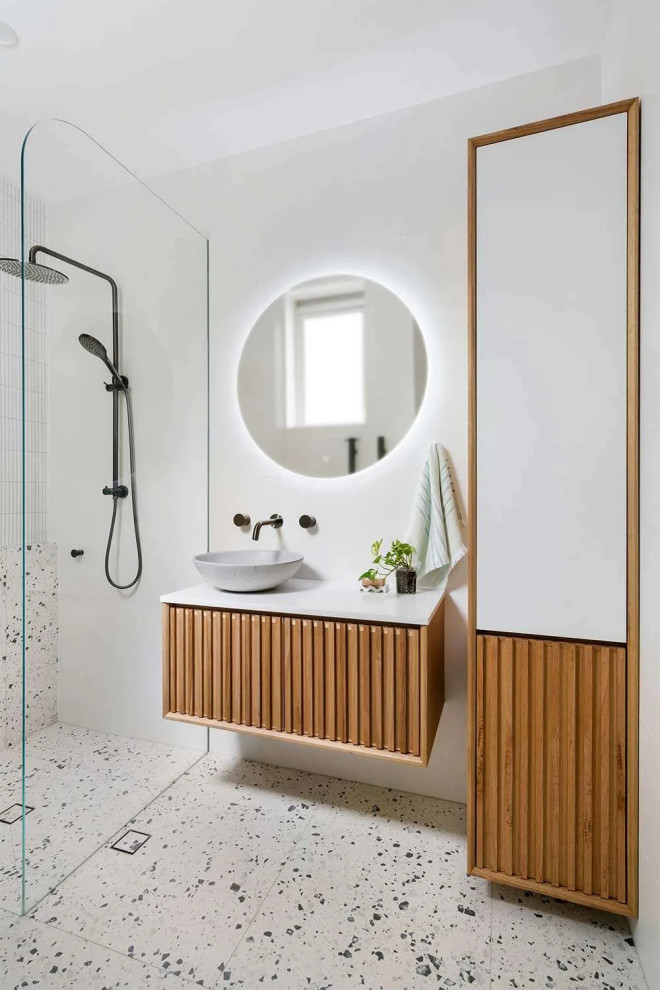 This is an example of a mid-sized master bathroom in Perth with furniture-like cabinets, light wood cabinets, an open shower, gray tile, ceramic tile, white walls, marble floors, a vessel sink, wood benchtops, grey floor, an open shower, white benchtops, a shower seat, a single vanity and a floating vanity.