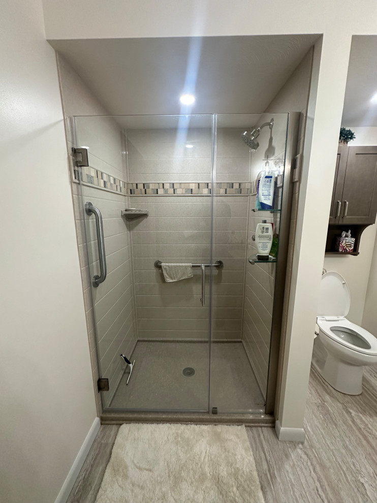 Bathroom Renovation with Glass-Enclosed Shower and Decorative Tile