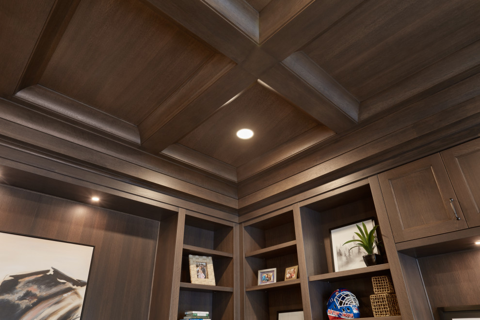 Photo of a traditional study in Edmonton with light hardwood flooring, a freestanding desk, brown floors, a coffered ceiling and wainscoting.