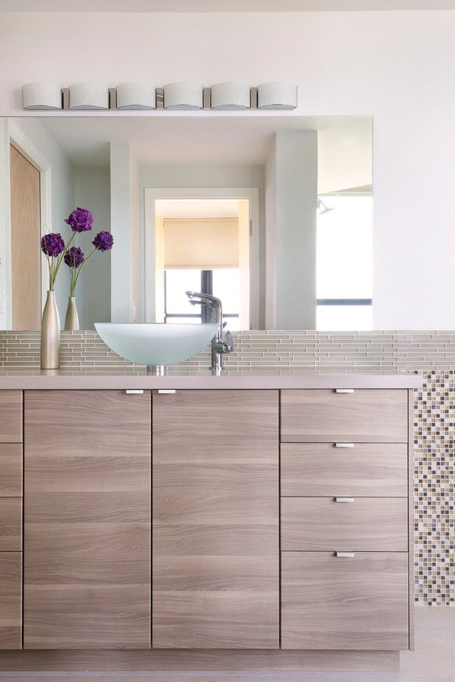 This is an example of a mid-sized contemporary bathroom in Miami with multi-coloured tile, mosaic tile, white walls, ceramic floors, a vessel sink, flat-panel cabinets and light wood cabinets.
