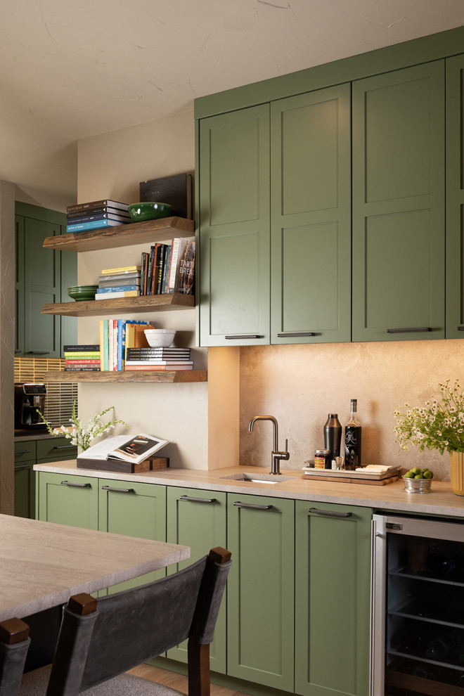 Transitional l-shaped open concept kitchen photo with an undermount sink, flat-panel cabinets, green cabinets, marble countertops, stainless steel appliances and an island