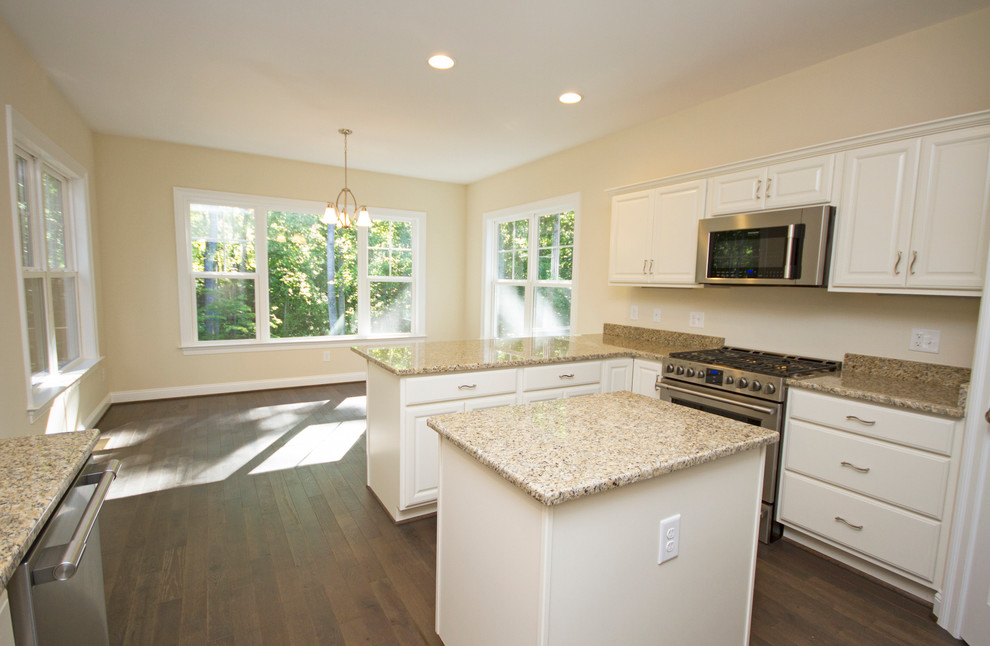 Inspiration for a large transitional u-shaped dark wood floor eat-in kitchen remodel in Richmond with a double-bowl sink, raised-panel cabinets, white cabinets, granite countertops, beige backsplash, stainless steel appliances and an island