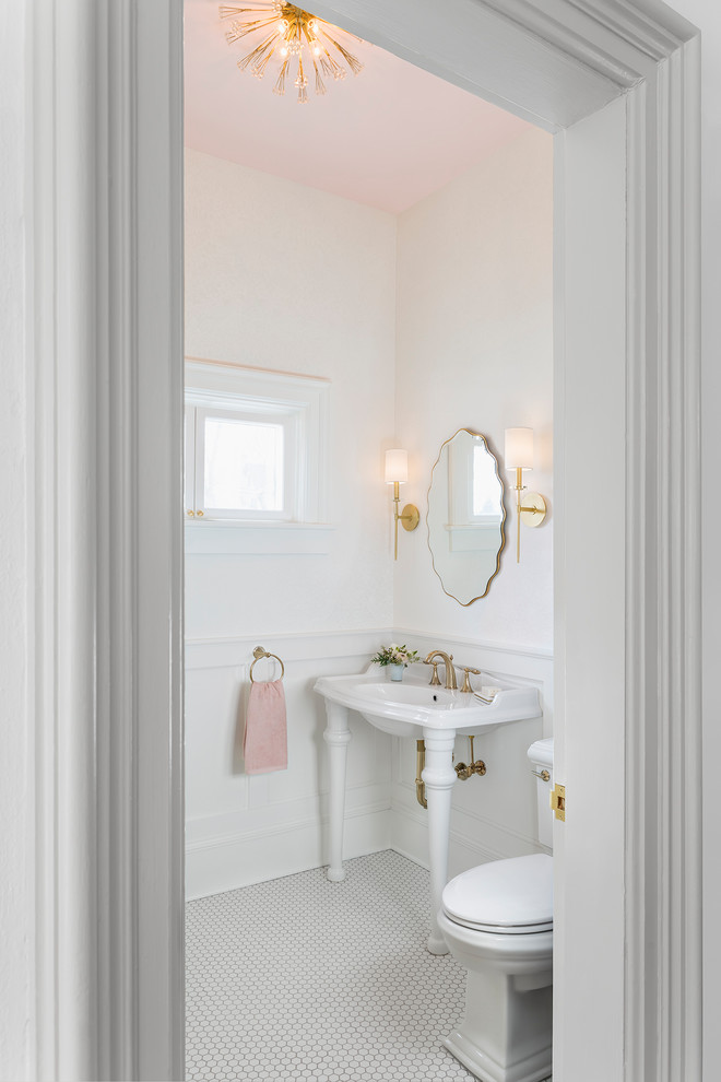 Example of a small classic white floor powder room design in Minneapolis with recessed-panel cabinets, white cabinets, a two-piece toilet, white walls and a console sink