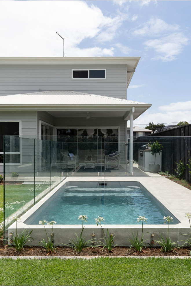Small farmhouse backyard concrete and rectangular aboveground pool photo