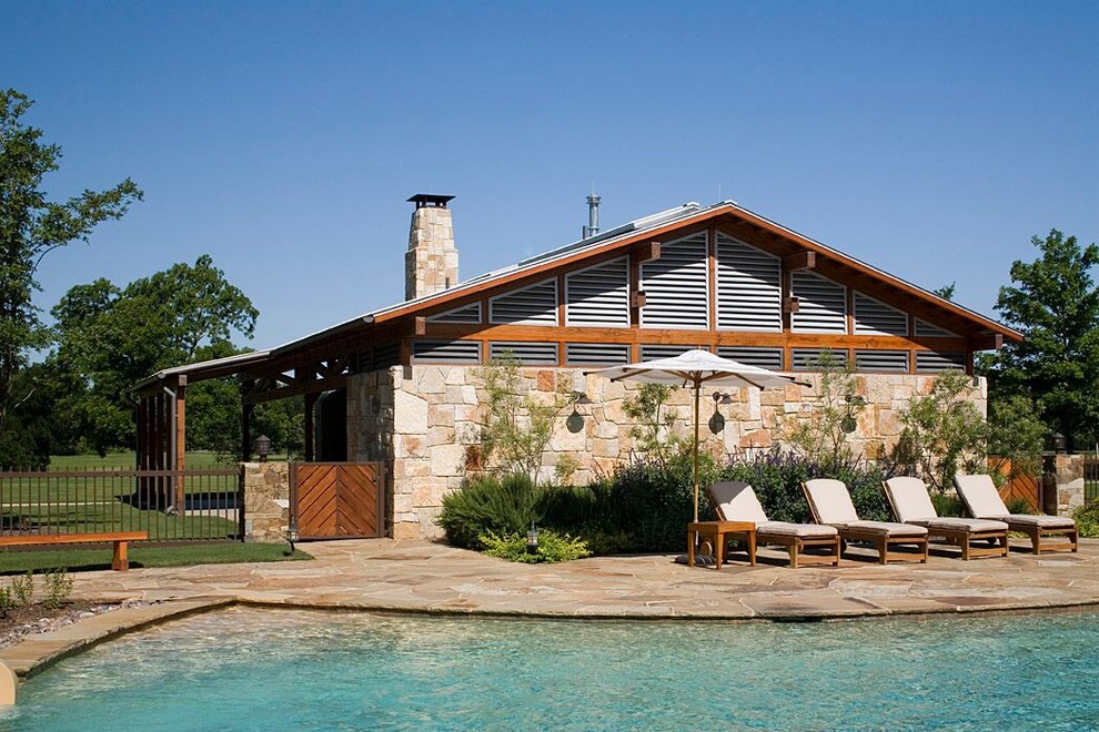 Inspiration for a mid-sized rustic backyard stone and custom-shaped natural water slide remodel in Austin