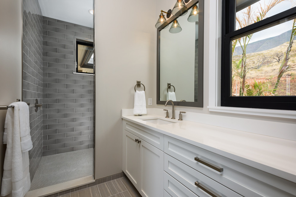 Design ideas for a mid-sized contemporary bathroom in Hawaii with shaker cabinets, white cabinets, an alcove shower, gray tile, ceramic tile, grey walls, porcelain floors, an undermount sink, engineered quartz benchtops and an open shower.