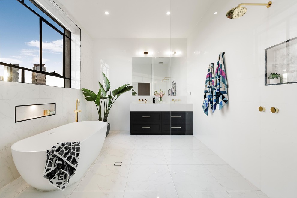 This is an example of a contemporary bathroom in Melbourne with flat-panel cabinets, black cabinets, a freestanding tub, an open shower, white tile and an open shower.