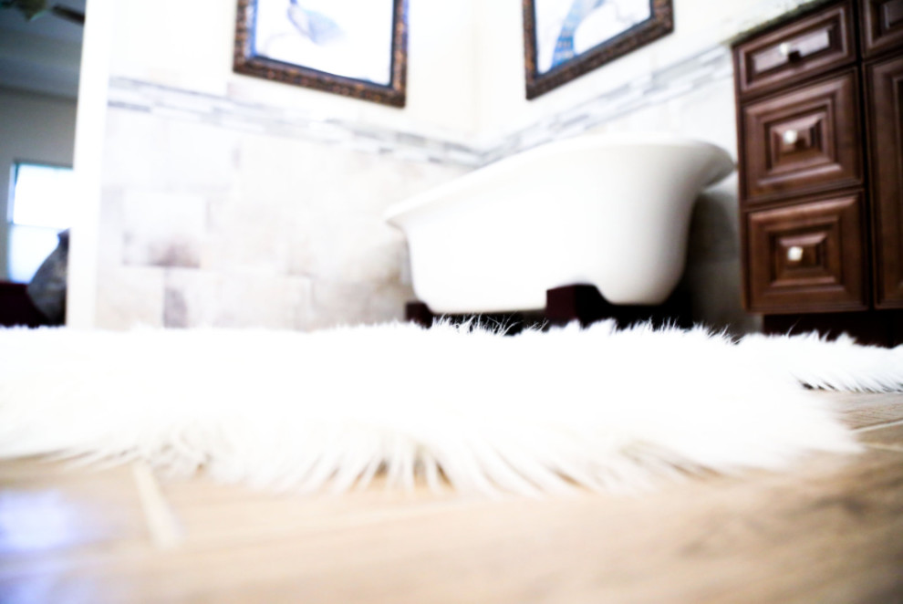 Example of a mid-sized transitional master black and white tile, gray tile and matchstick tile light wood floor claw-foot bathtub design with raised-panel cabinets, dark wood cabinets, multicolored walls, granite countertops and a vessel sink