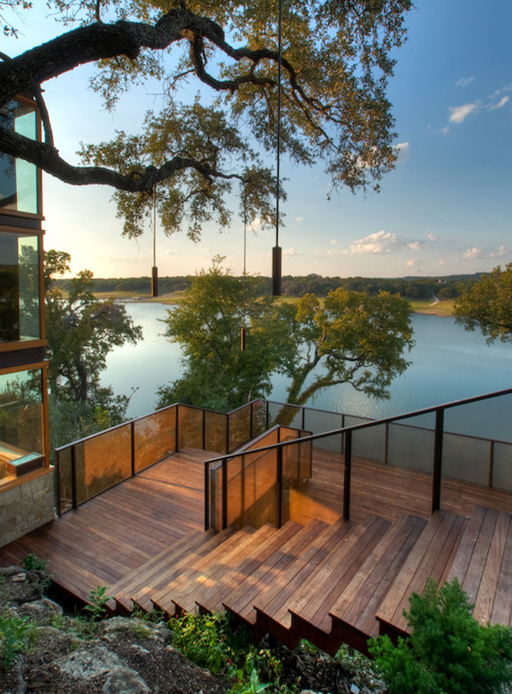 This is an example of a contemporary sloped garden in Austin with decking.