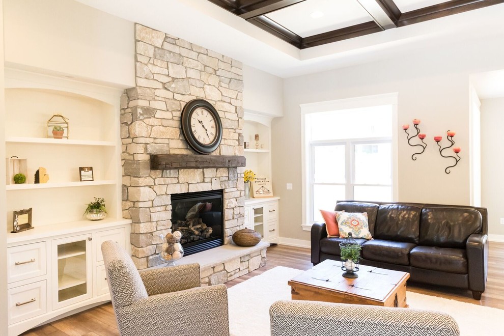 Mid-sized transitional open concept living room in Grand Rapids with beige walls, light hardwood floors, a standard fireplace, a stone fireplace surround, no tv and brown floor.