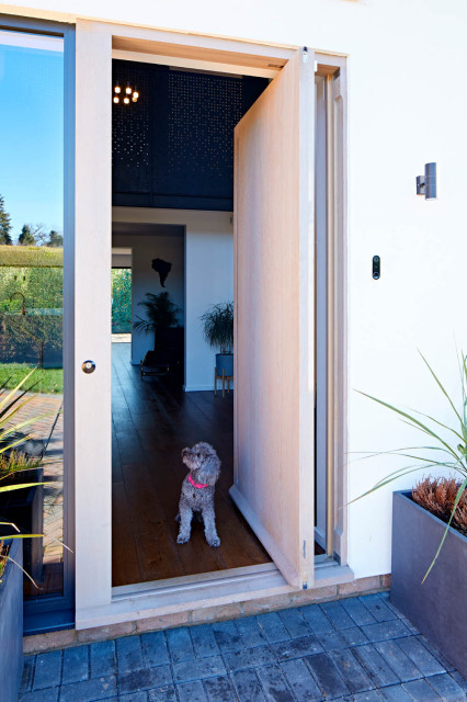 Vista e80 Oak with a grey oil pivot doorset contemporary-exterior