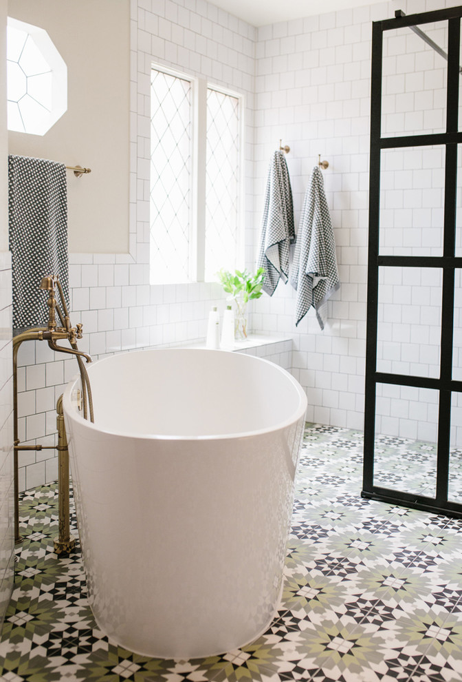 Inspiration for a transitional master bathroom in Austin with white tile, beige walls, an open shower, a freestanding tub, a curbless shower, ceramic tile, cement tiles and multi-coloured floor.