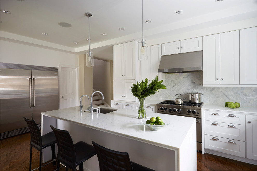 Eat-in kitchen - mid-sized transitional u-shaped medium tone wood floor eat-in kitchen idea in Chicago with an undermount sink, shaker cabinets, white cabinets, solid surface countertops, blue backsplash, stone tile backsplash, stainless steel appliances and an island