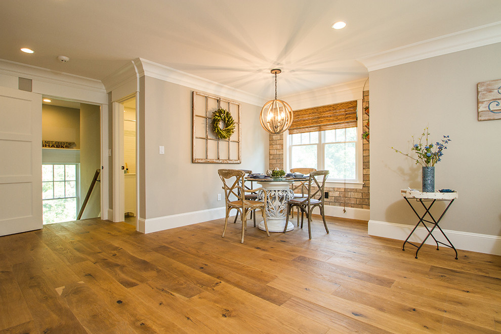 This is an example of a small country open plan dining in Boston with beige walls, light hardwood floors and no fireplace.