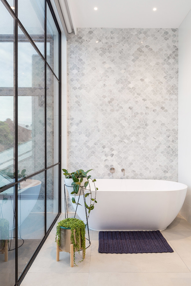 Photo of a mid-sized contemporary master wet room bathroom in Melbourne with light wood cabinets, a freestanding tub, white tile, mosaic tile, white walls, porcelain floors, marble benchtops, grey floor, a hinged shower door and white benchtops.