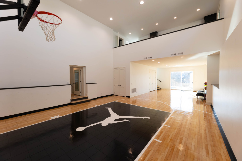Medium sized contemporary indoor sports court in Minneapolis with white walls, light hardwood flooring and brown floors.