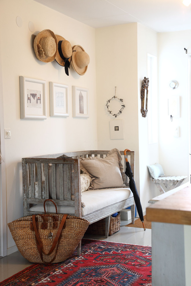 Inspiration for a large country entry hall in Malmo with beige walls and painted wood floors.