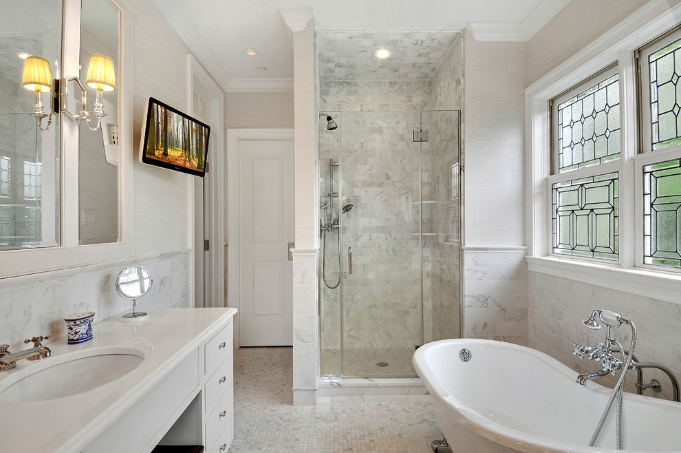 Inspiration for a traditional master bathroom in New York with grey cabinets, a claw-foot tub, an alcove shower, gray tile, an undermount sink, grey floor and a hinged shower door.