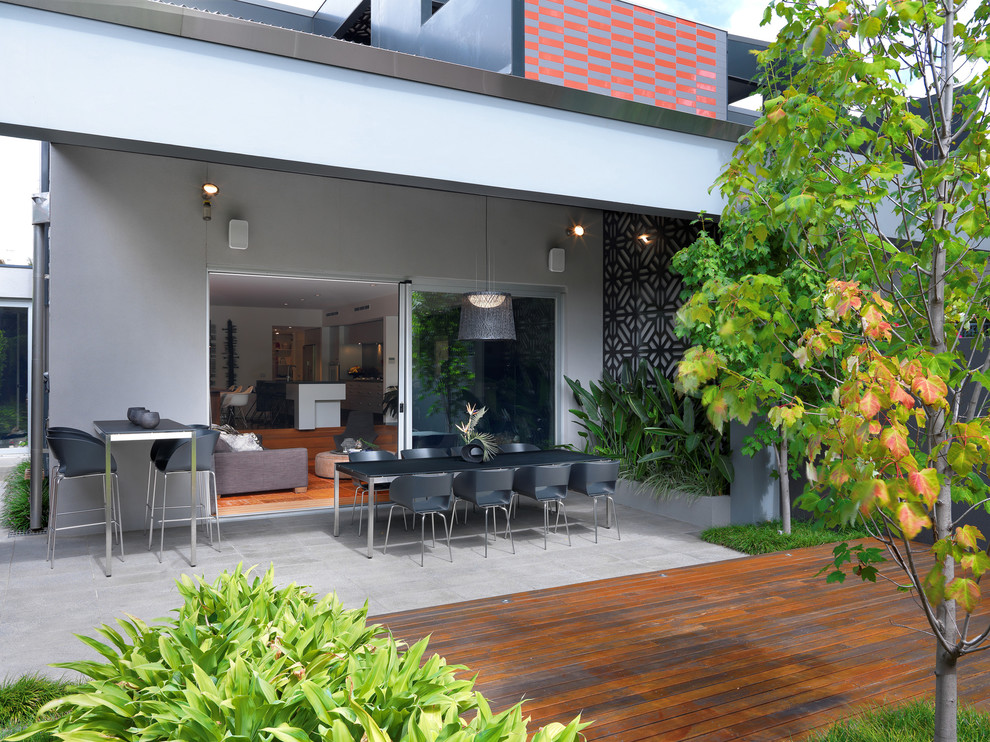 Design ideas for a mid-sized contemporary backyard patio in Melbourne with a roof extension.