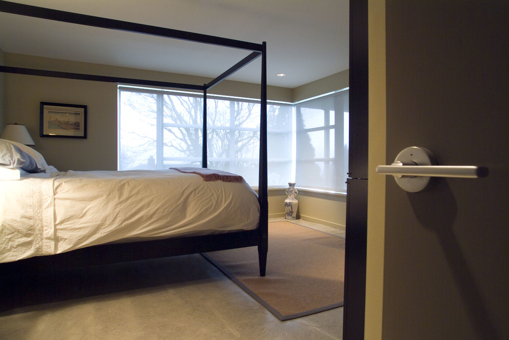This is an example of a modern master bedroom in Burlington with beige walls.