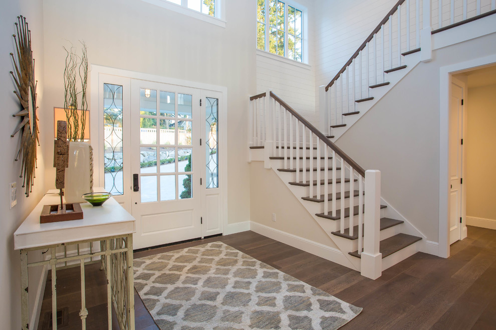 Design ideas for a country foyer in Seattle with beige walls, dark hardwood floors, a single front door and a glass front door.