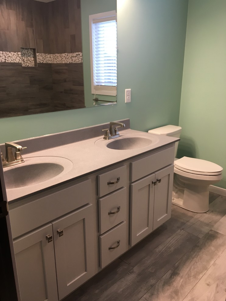 Design ideas for a mid-sized transitional master bathroom in Cedar Rapids with recessed-panel cabinets, white cabinets, an open shower, gray tile, porcelain tile, blue walls, porcelain floors, an integrated sink, marble benchtops and grey floor.