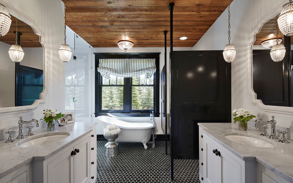 This is an example of a transitional master bathroom in Minneapolis with an undermount sink, recessed-panel cabinets, white cabinets, marble benchtops, a claw-foot tub, mosaic tile, white walls, mosaic tile floors, black and white tile, black floor, an alcove shower and a hinged shower door.