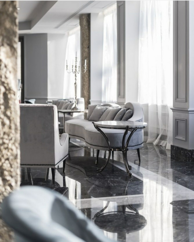 This is an example of an expansive traditional foyer in Lyon with grey walls, marble floors, a sliding front door, a glass front door, black floor, recessed and decorative wall panelling.