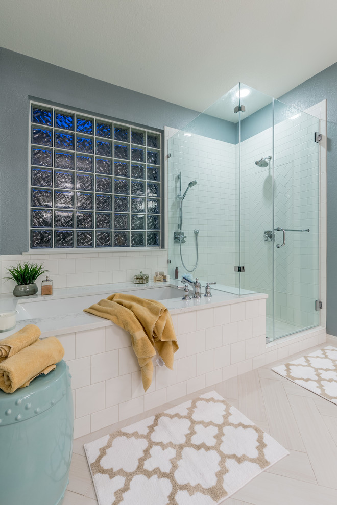 Example of a mid-sized transitional master white tile and ceramic tile porcelain tile corner shower design in Austin with shaker cabinets, white cabinets, an undermount tub, gray walls, an undermount sink and quartz countertops
