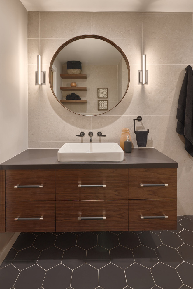 Photo of a mid-sized modern 3/4 bathroom in San Francisco with flat-panel cabinets, dark wood cabinets, a curbless shower, a one-piece toilet, porcelain tile, beige walls, porcelain floors, a vessel sink, solid surface benchtops, black floor, an open shower, a niche, a single vanity and a floating vanity.