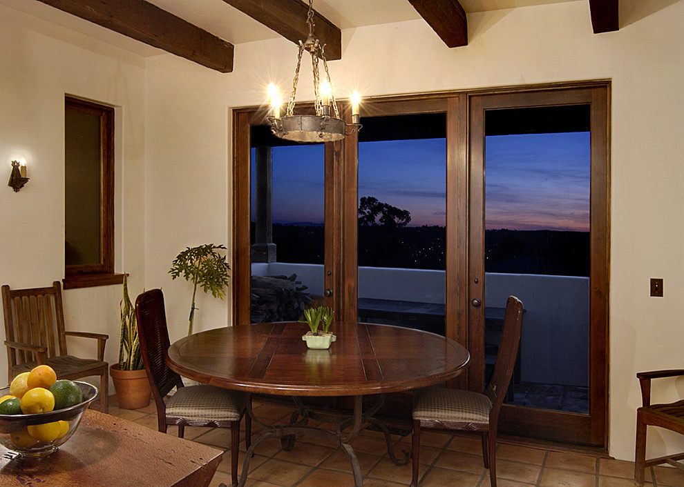 This is an example of a small mediterranean separate dining room in Santa Barbara with terra-cotta floors.