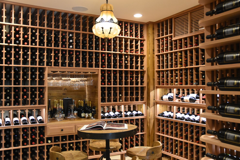 Design ideas for a large modern wine cellar in Orange County with porcelain floors, display racks and beige floor.