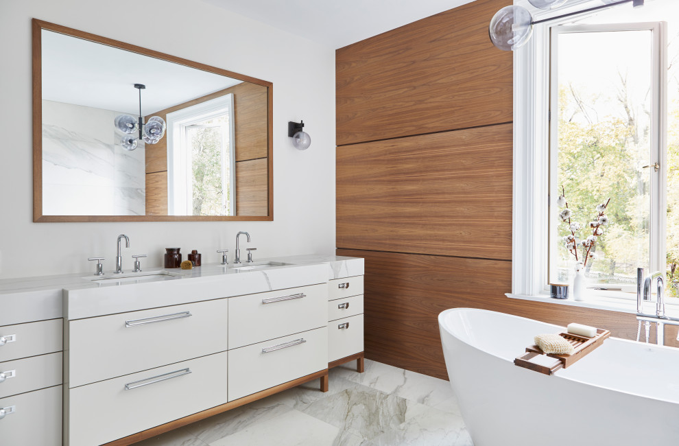 Photo of a mid-sized contemporary master bathroom in Toronto with a freestanding tub, ceramic floors, an undermount sink, white floor, white benchtops, flat-panel cabinets, white cabinets and white walls.