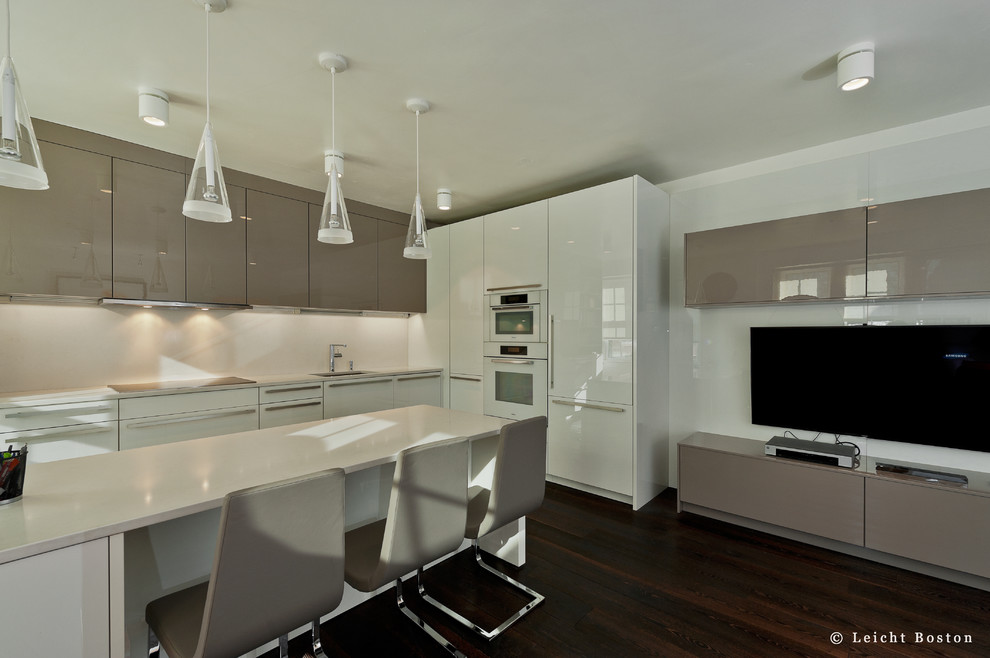 Small modern kitchen in Boston with an undermount sink, flat-panel cabinets, white cabinets, quartz benchtops, white appliances and with island.