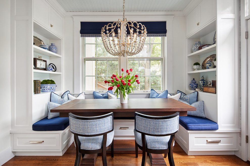 Kitchen/dining room combo - mid-sized traditional medium tone wood floor and brown floor kitchen/dining room combo idea in Austin with white walls