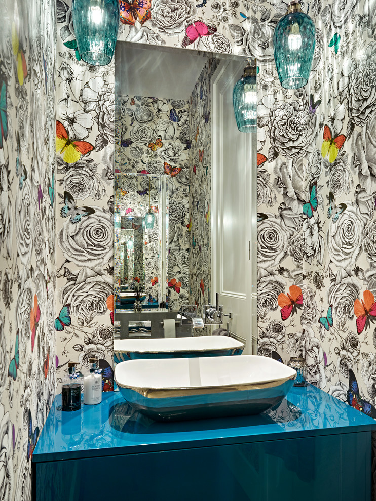 Inspiration for an eclectic powder room in London with a vessel sink and blue benchtops.