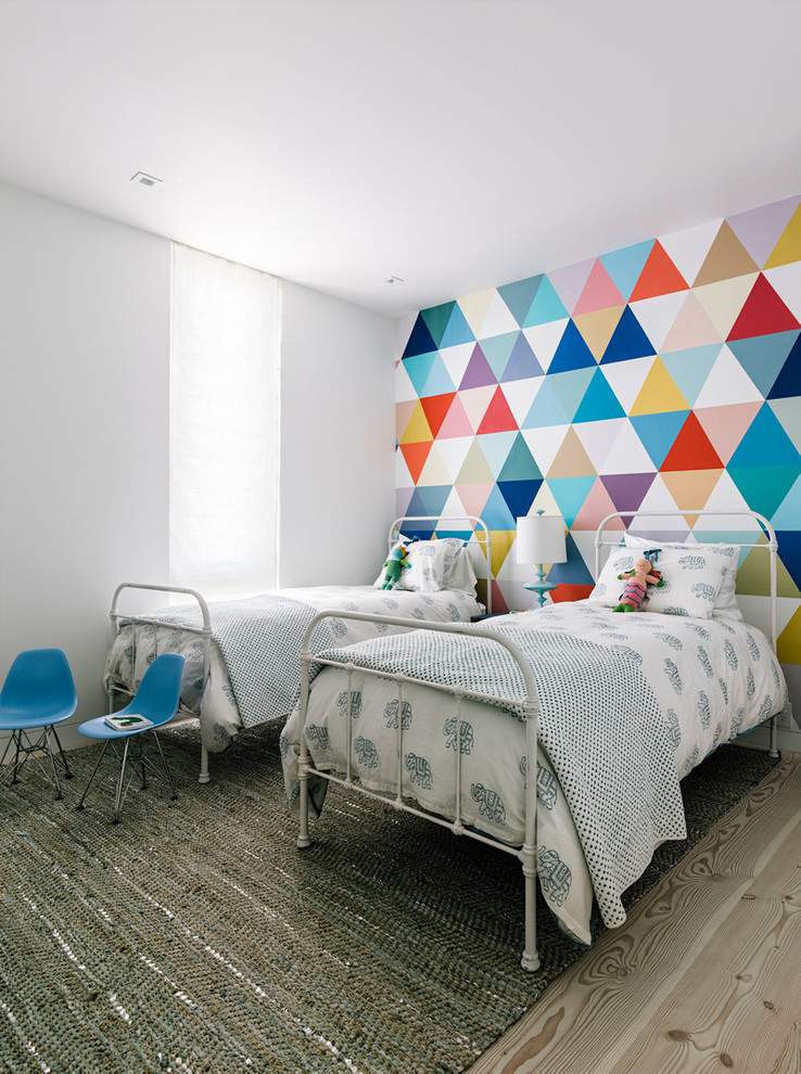 Design ideas for a contemporary gender-neutral kids' bedroom for kids 4-10 years old in San Francisco with light hardwood floors and multi-coloured walls.