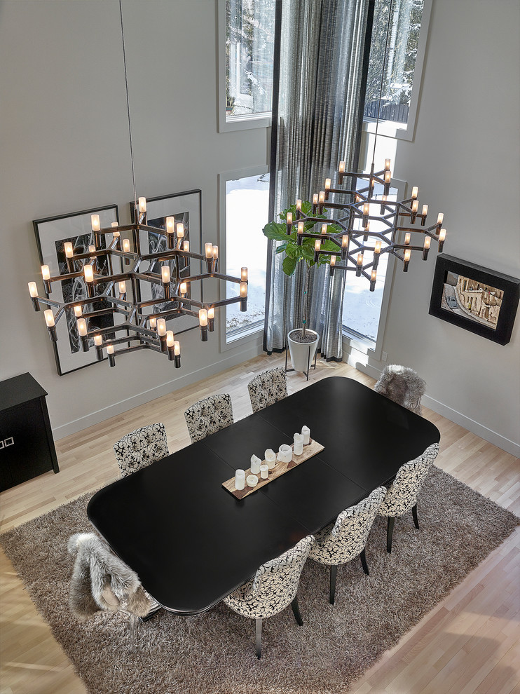 Photo of a large contemporary open plan dining in Edmonton with grey walls and light hardwood floors.