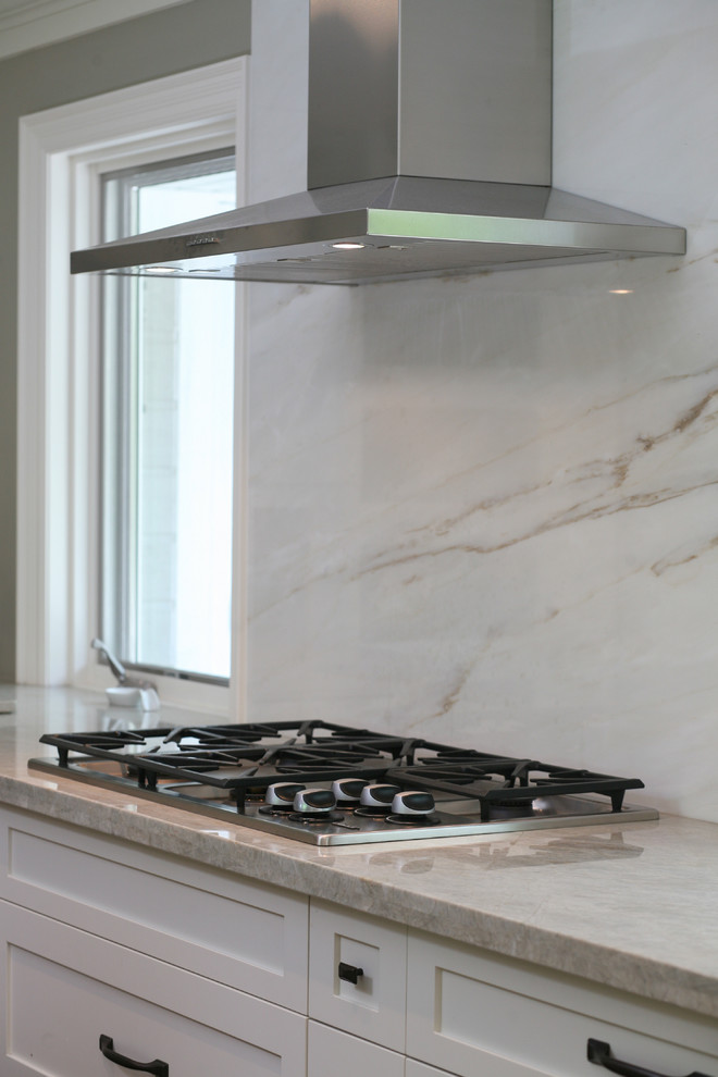 Inspiration for a large transitional l-shaped dark wood floor and brown floor eat-in kitchen remodel in Toronto with an undermount sink, shaker cabinets, white cabinets, stainless steel appliances and an island
